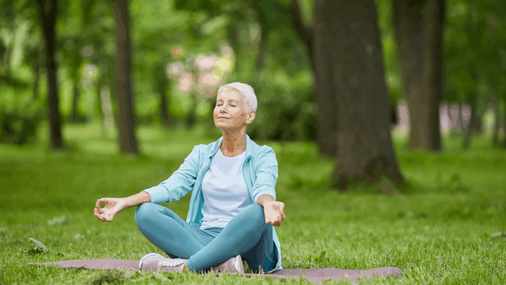 woman sitting on the grass meditating