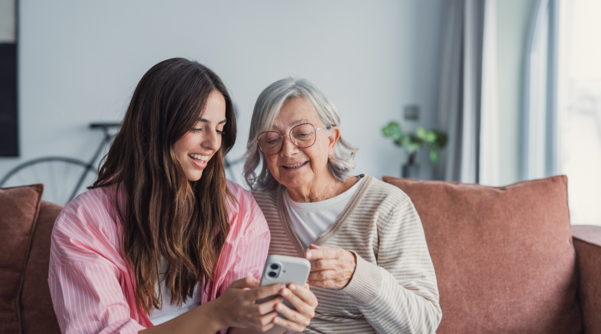 old woman looking at the phone of a younger woman